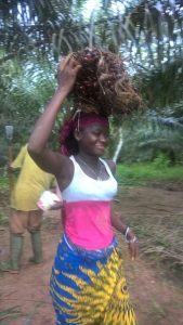 Ivorian woman with palm oil pods - Palm Oil Cote d'Ivoire - SDG Goal 8: Decent Work and Economic Growth - Promote inclusive and sustainable economic growth, employment and decent work for all - United Nations Sustainable Development | AgriSmart #blog